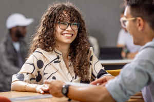 Two students talking at a table